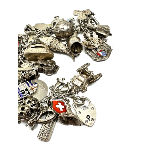 351 - A vintage silver charm bracelet with assorted novelty charms (123g)