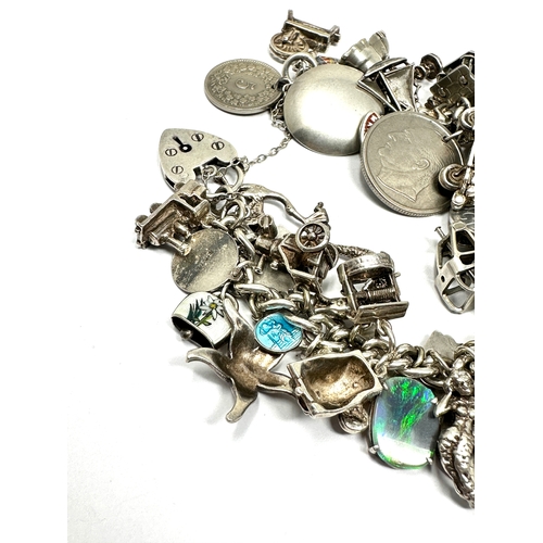 317 - A vintage silver charm bracelet with assorted novelty charms (102g)