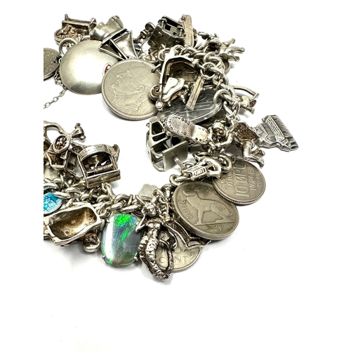 317 - A vintage silver charm bracelet with assorted novelty charms (102g)