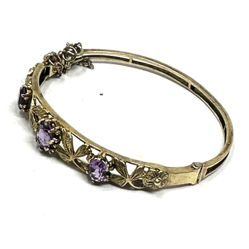 313 - A decorative silver bangle set with amethyst (13g)