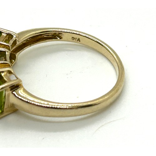 411 - 9ct gold peridot and diamond ring UK size M. Gross weight 2.6 grams