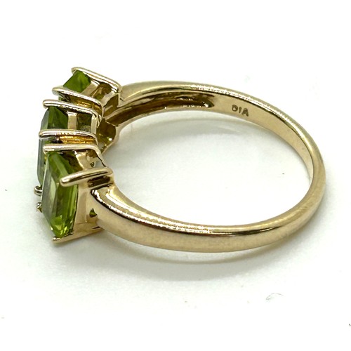 411 - 9ct gold peridot and diamond ring UK size M. Gross weight 2.6 grams