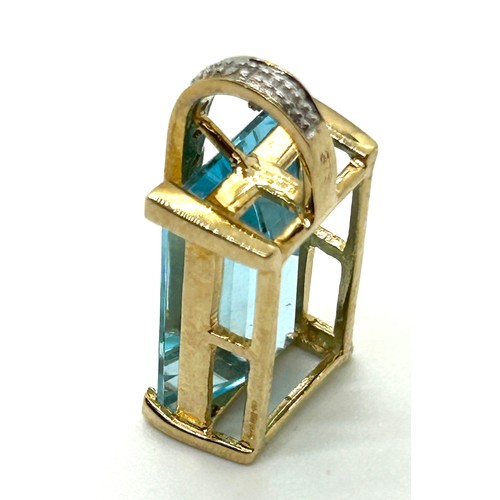 412 - 9ct gold diamond and topaz pendant weight 4.3 grams