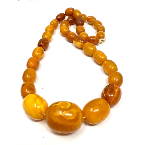 153 - Egg Yolk amber bead necklace weight 66g