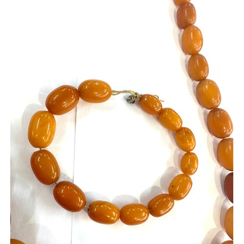 545A - Antique egg yolk amber bead necklace and bracelet with internal streaking total weight 82grams large... 