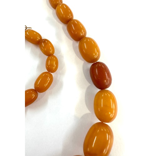 545A - Antique egg yolk amber bead necklace and bracelet with internal streaking total weight 82grams large... 