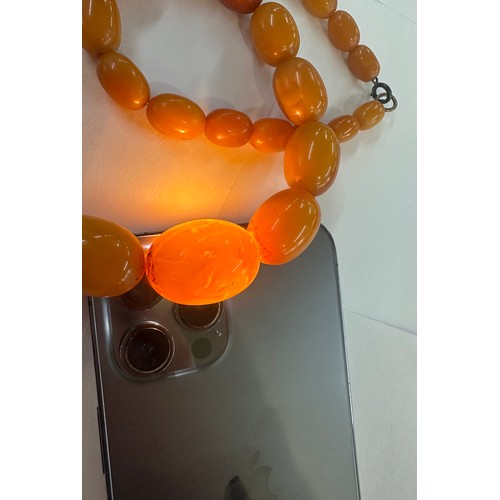 545A - Antique egg yolk amber bead necklace and bracelet with internal streaking total weight 82grams large... 