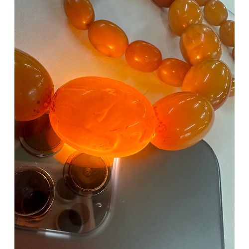 545A - Antique egg yolk amber bead necklace and bracelet with internal streaking total weight 82grams large... 