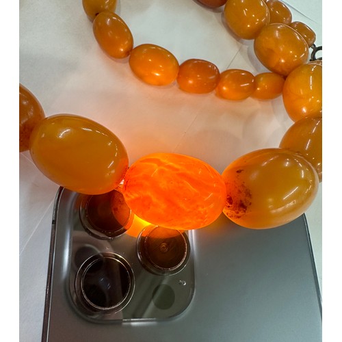 545A - Antique egg yolk amber bead necklace and bracelet with internal streaking total weight 82grams large... 