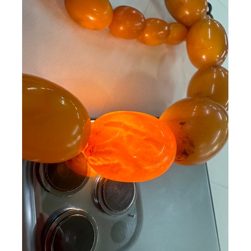 545A - Antique egg yolk amber bead necklace and bracelet with internal streaking total weight 82grams large... 