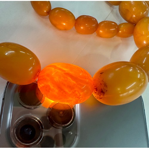 545A - Antique egg yolk amber bead necklace and bracelet with internal streaking total weight 82grams large... 