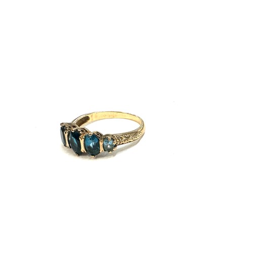 445 - 9ct gold ting with london blue topaz stones unmarked but tested 9ct size R weight 3.2 grams