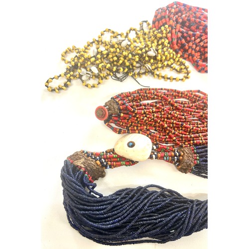 477 - Naga tribal beadwork necklace together with a selection of other bead necklaces