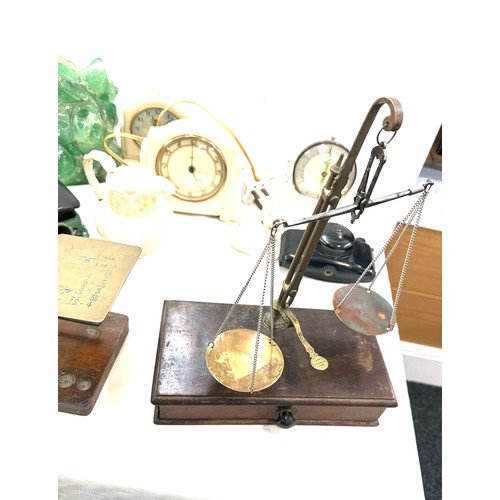 184 - 2 sets brass scales 1 postal scales, 1 balance scales and 3 bakelite clocks etc