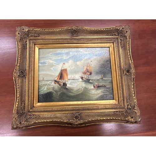 24 - Gilt framed oil on boards depicting gallions measures approximately 24 inches tall 19 inches wide