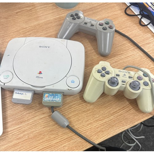 166 - 2 x  Play station 2s and a playstation 1 console, 5 controllers and a selection of assorted games, u... 