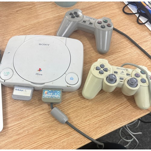 166 - 2 x  Play station 2s and a playstation 1 console, 5 controllers and a selection of assorted games, u... 