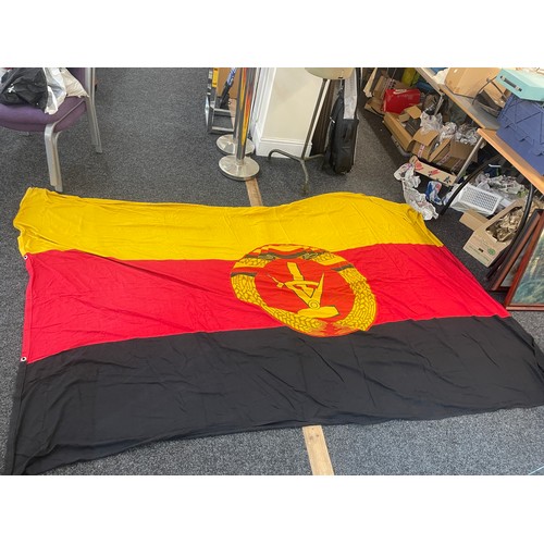 93 - East German flag measures approximately 110inches by 62 inches