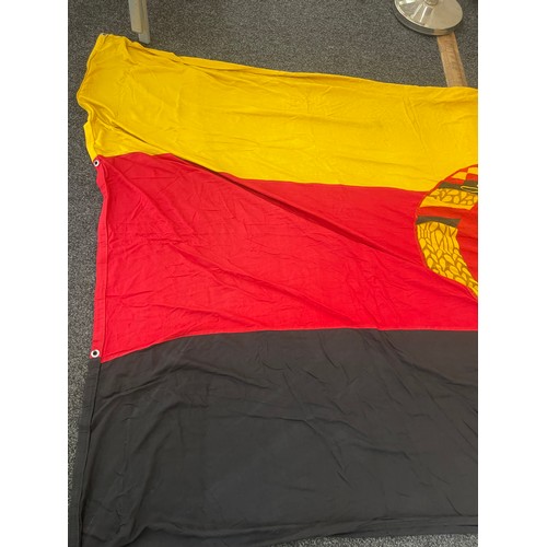 93 - East German flag measures approximately 110inches by 62 inches