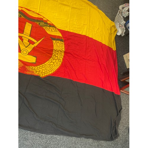 93 - East German flag measures approximately 110inches by 62 inches