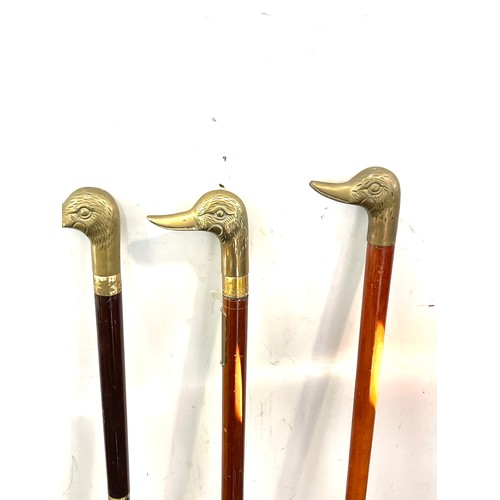 105 - Selection of vintage wooden walking sticks with brass duck head handles (4 in total)