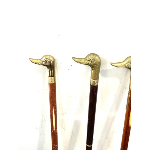 105 - Selection of vintage wooden walking sticks with brass duck head handles (4 in total)