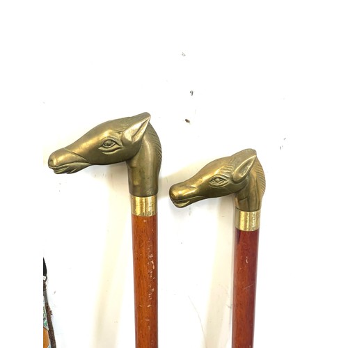 110 - Selection of vintage wooden walking sticks with brass handles includes horse, dog, dolphin etc