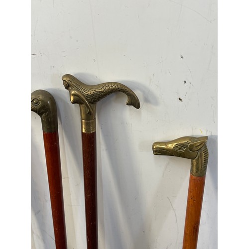 107A - Selection of vintage wooden walking sticks with brass handles includes mermaid, duck, dog and horse