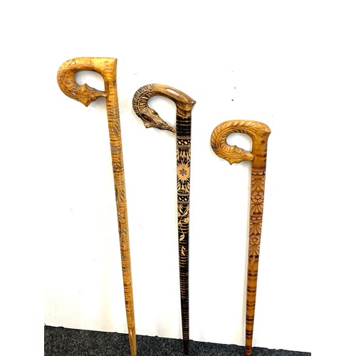 148 - Three vintage carved handled walking sticks