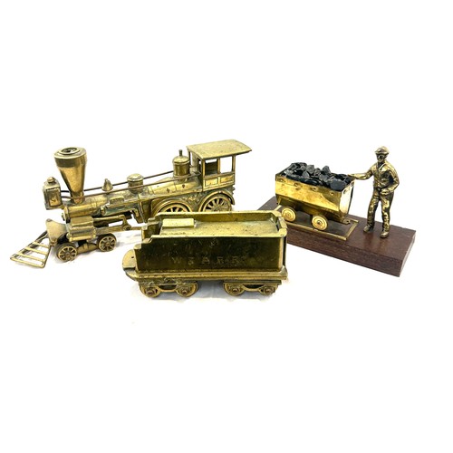 43 - Brass train and tender, miner figure, approximate measurement of train and tender: 20 inches, height... 