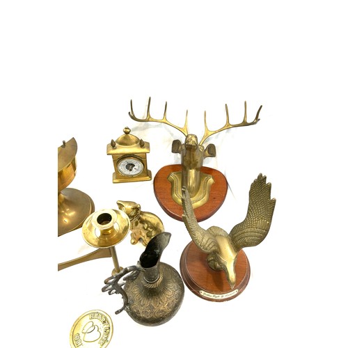 206 - Selection of brassware to include candle stick holder, oil lamp, mantel clock etc