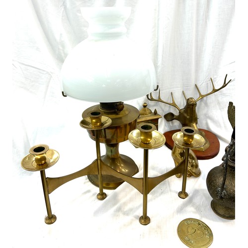 206 - Selection of brassware to include candle stick holder, oil lamp, mantel clock etc