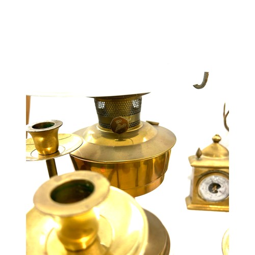 206 - Selection of brassware to include candle stick holder, oil lamp, mantel clock etc