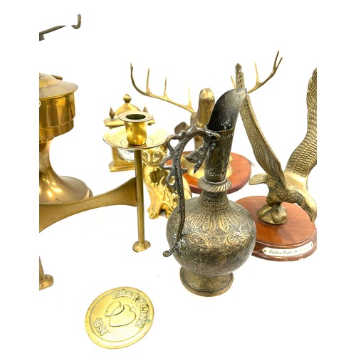 206 - Selection of brassware to include candle stick holder, oil lamp, mantel clock etc