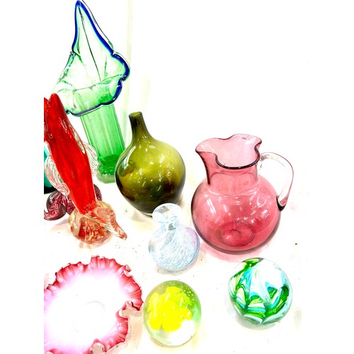 110 - Large selection of coloured glassware to include fish paperweight, carnival glass, cranberry etc