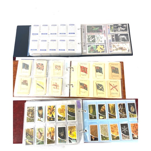 88 - Selection of cigarette/ tea/ collectors cards in three albums includes full sets includes players, w... 