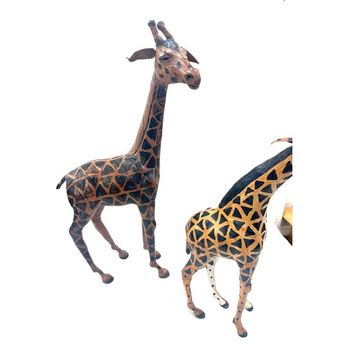 94 - 2 leather giraffe figures, tallest measures approximately 21 inches tall