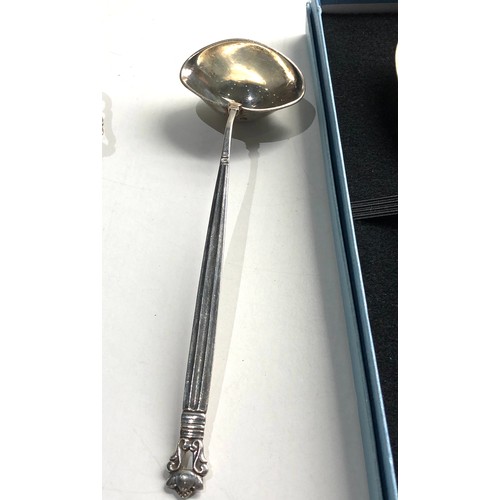 442 - 2 silver spoons and silver tea strainer