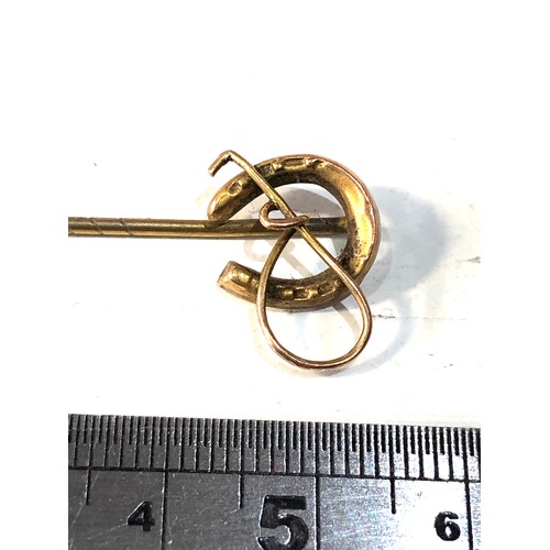 573 - 9ct gold horseshoe & crop stick pin weight 1.6g