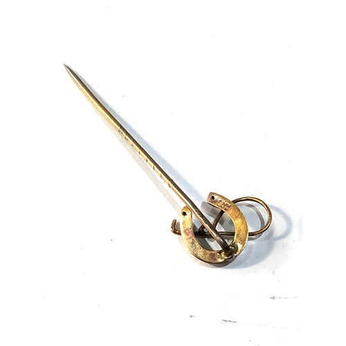 573 - 9ct gold horseshoe & crop stick pin weight 1.6g