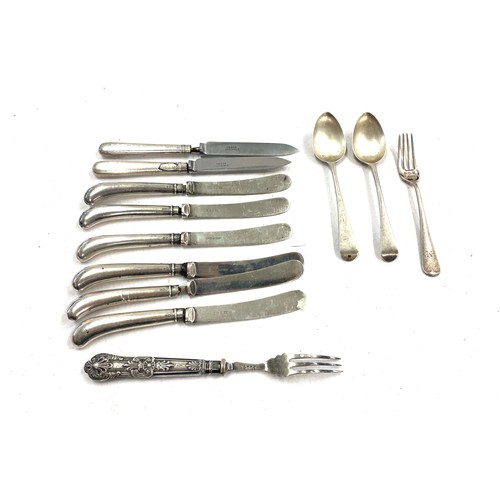 521 - 12 silver items includes spoons, knives, forks etc