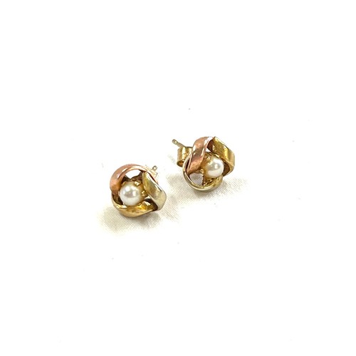 561 - Pair 9ct gold two tone ladies pearl set earrings, knot design.