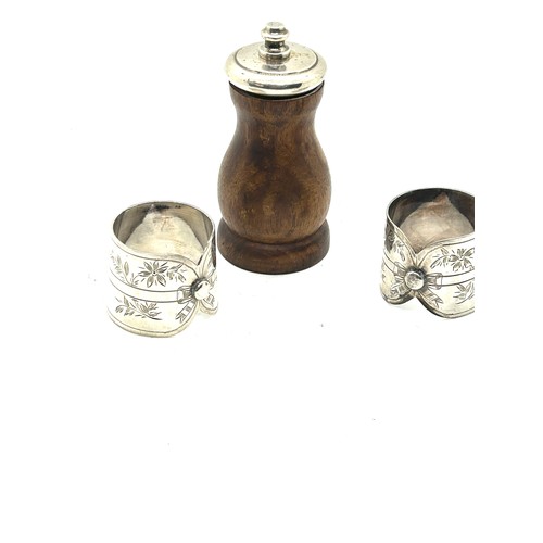 427 - Sterling silver top pepper grinder and pair of silver plated shirt collar napkin rings