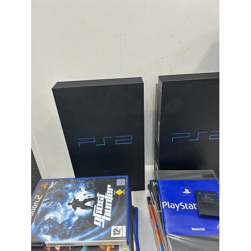 242 - 2 Playstation 2 consoles, no controllers, with leads and memory cards, to include some playstation g... 