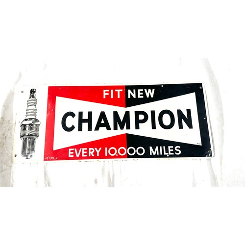 98 - Champion spark plugs  tin advertising sign measures approximately 9.5 inches tall 23 inches wide