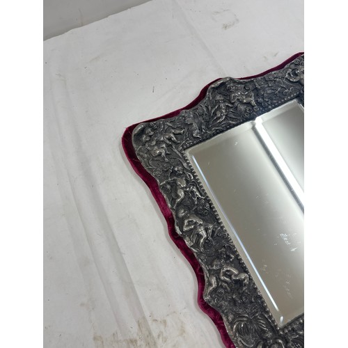 457 - Ornate silver plated mirror with cherrub design measures approx 15 inches tall by 13 width