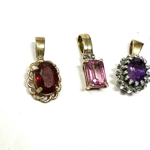 149 - 4x 9ct gold diamond, amethyst, garnet, pink topaz & white gemstone pendant (2.7g)