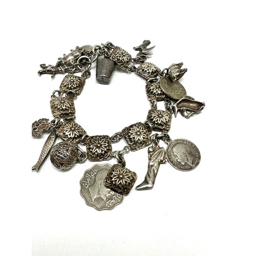 323 - Two silver charm bracelets including coin charms (100g)