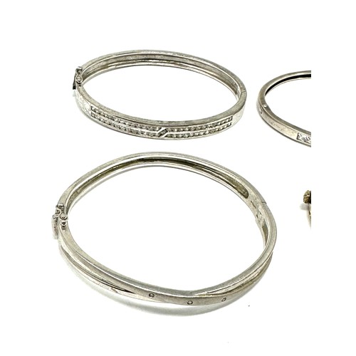 343 - Four silver CZ bangles (62g)