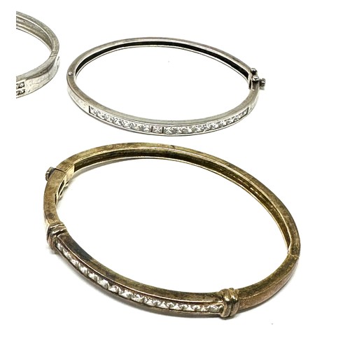 343 - Four silver CZ bangles (62g)